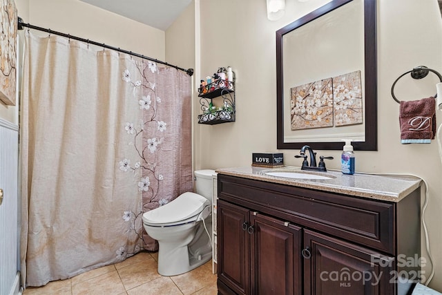 bathroom with vanity, tile patterned flooring, and toilet