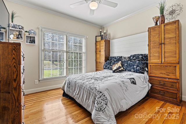 bedroom with light wood-style floors, crown molding, baseboards, and ceiling fan