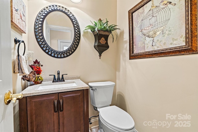 half bath featuring toilet and vanity