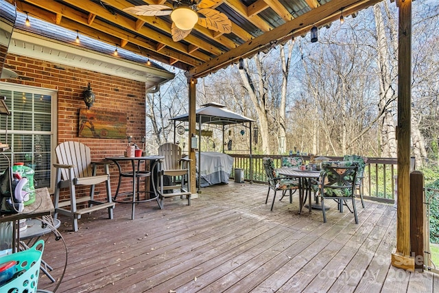 deck featuring ceiling fan and outdoor dining area