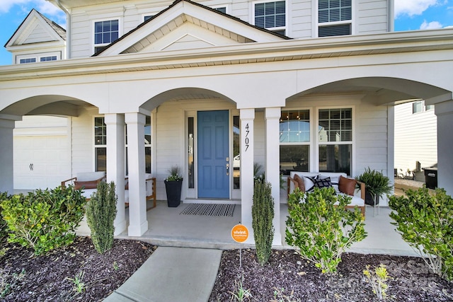 entrance to property with a porch and a garage