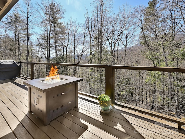 deck with a fire pit and area for grilling