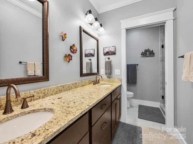 bathroom featuring ornamental molding, a sink, toilet, and double vanity