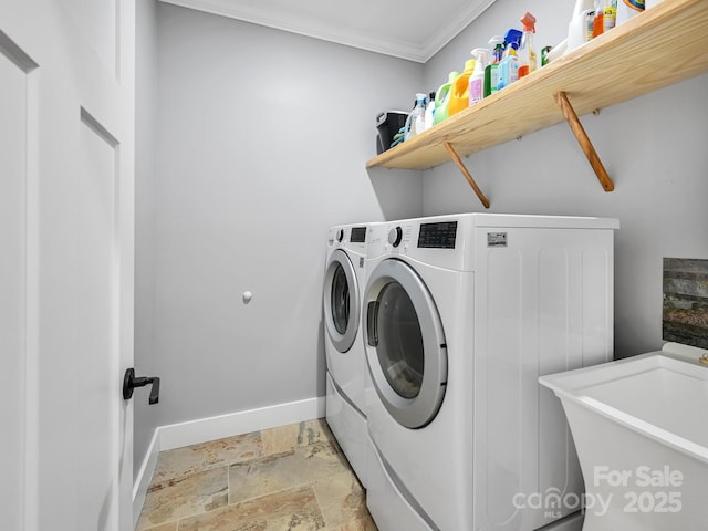 laundry room featuring laundry area, baseboards, washer and clothes dryer, crown molding, and stone tile flooring