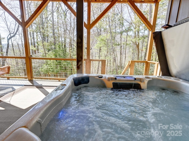 sunroom / solarium with a jacuzzi