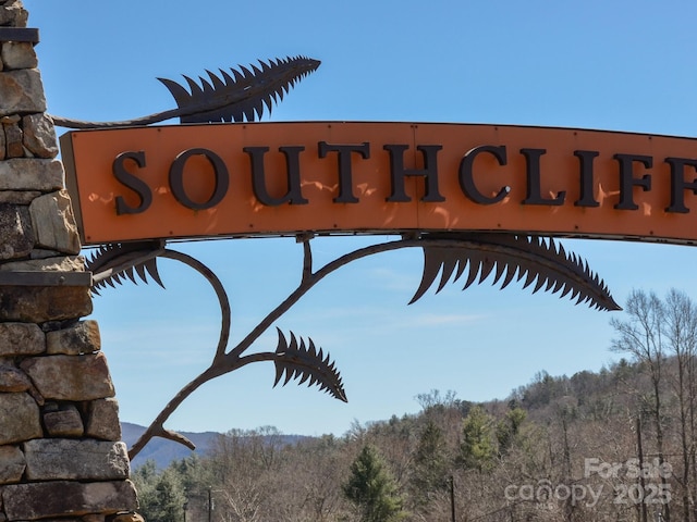 community sign with a forest view