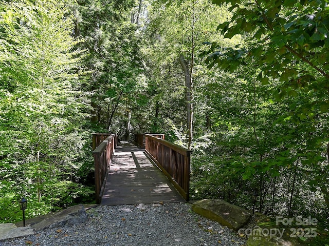 view of home's community featuring a forest view