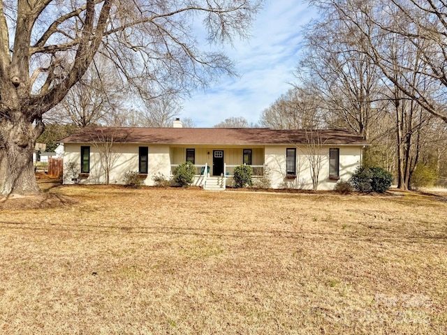 ranch-style house with a front lawn and a chimney