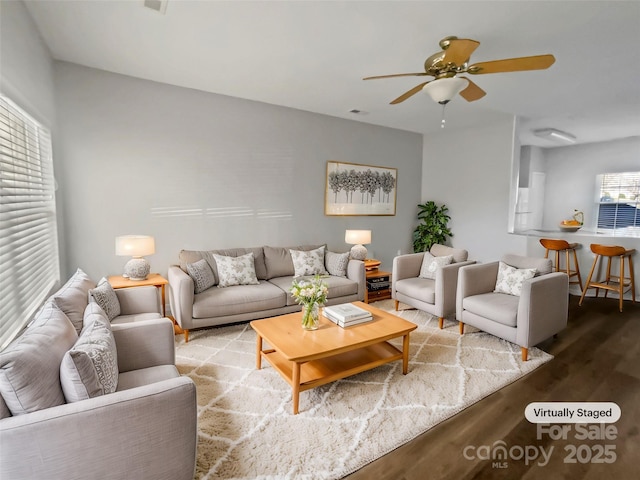 living area with ceiling fan and wood finished floors