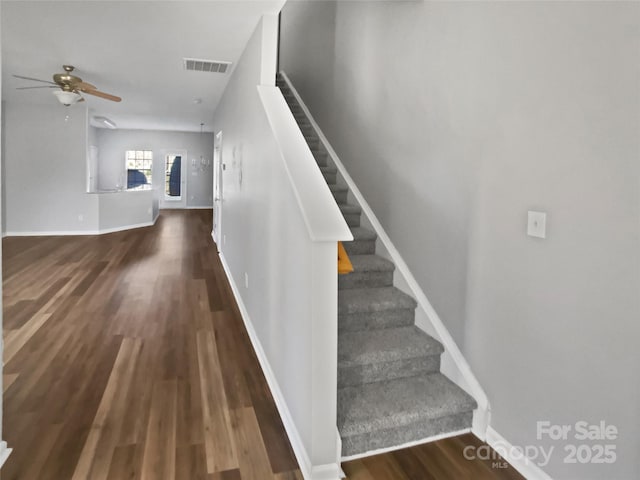 stairs featuring baseboards, visible vents, ceiling fan, and wood finished floors