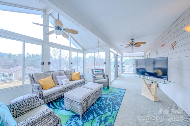 sunroom / solarium with lofted ceiling with beams and a ceiling fan