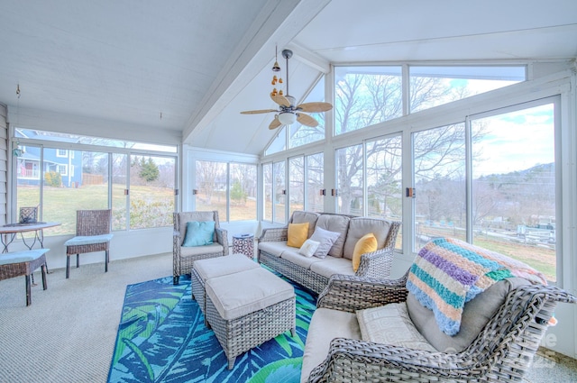 sunroom with lofted ceiling with beams and a ceiling fan