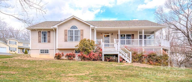 view of front facade with covered porch, stairs, and a front lawn