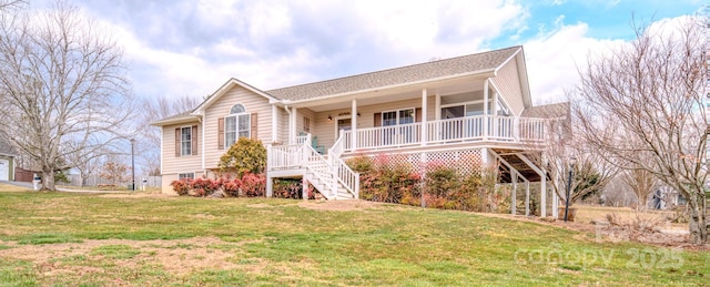 view of front of home featuring covered porch, stairway, and a front lawn