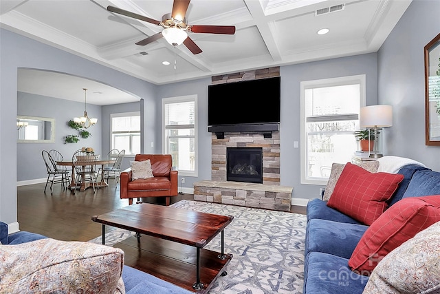 living area with a healthy amount of sunlight, visible vents, coffered ceiling, and wood finished floors