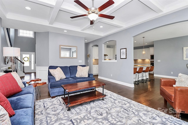 living area with beamed ceiling, stairway, dark wood-style flooring, and coffered ceiling