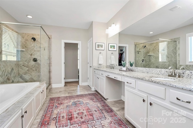 full bathroom featuring a garden tub, a sink, visible vents, double vanity, and a stall shower