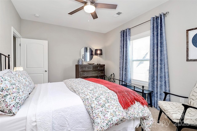 carpeted bedroom with ceiling fan and visible vents