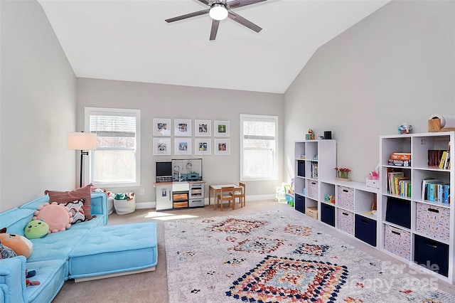 living room with vaulted ceiling, ceiling fan, carpet, and baseboards