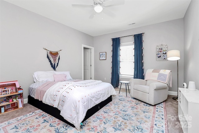 bedroom with light colored carpet, visible vents, ceiling fan, and baseboards