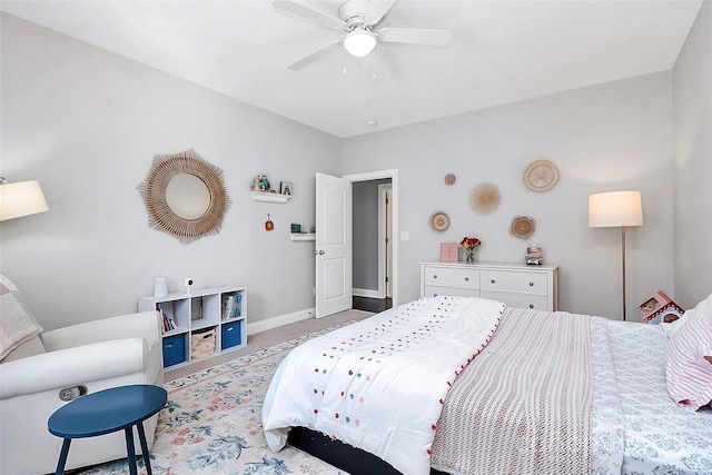 carpeted bedroom with ceiling fan and baseboards