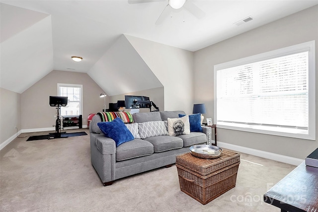 living room with vaulted ceiling, baseboards, visible vents, and light colored carpet