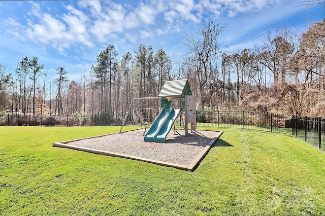 communal playground with fence and a lawn