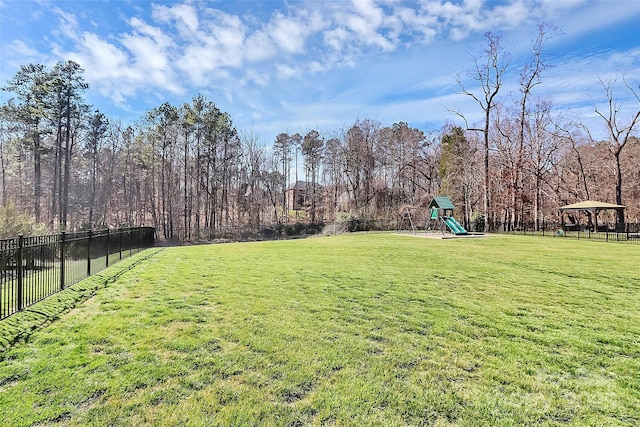 view of yard with playground community and fence