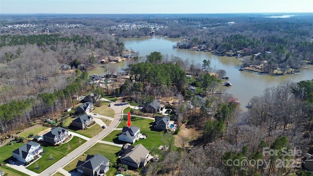 aerial view featuring a water view, a residential view, and a wooded view