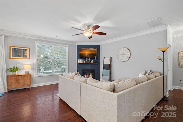 living room featuring a large fireplace, baseboards, dark wood finished floors, and crown molding