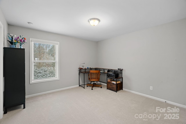 home office with light carpet and baseboards