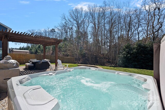 view of swimming pool featuring a hot tub, fence, and a pergola