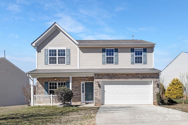 traditional home with a garage, concrete driveway, a porch, and brick siding