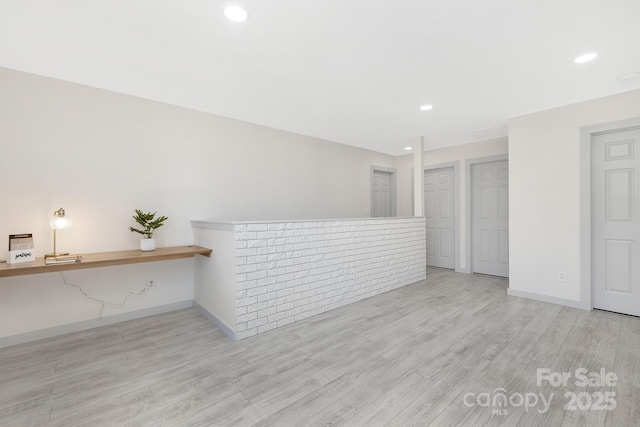 spare room with recessed lighting, light wood-style flooring, and baseboards