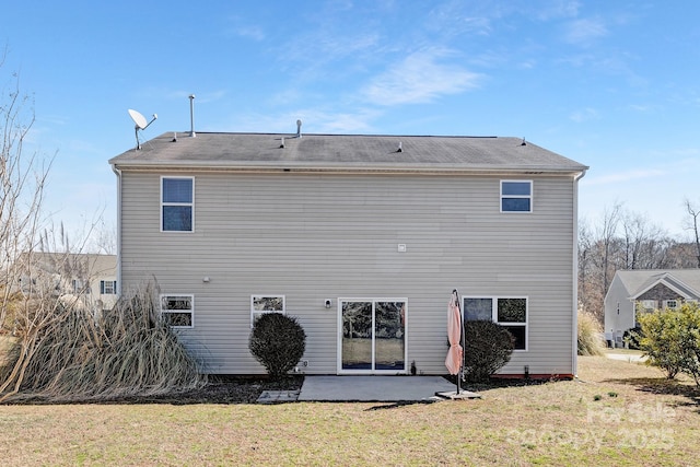 rear view of property with a yard and a patio