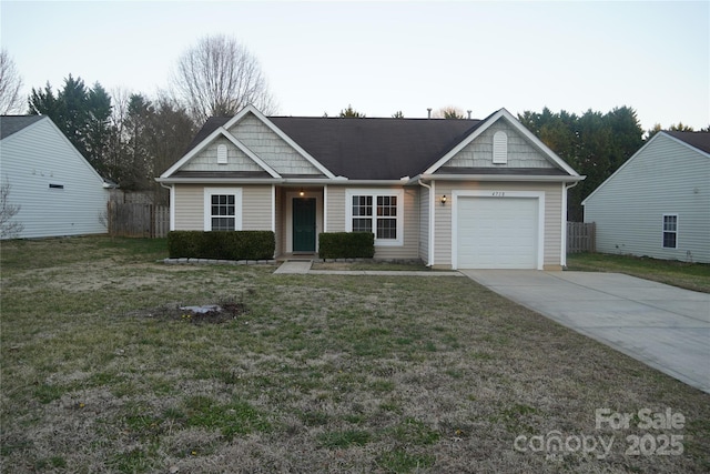 view of front facade with driveway, an attached garage, and a front yard