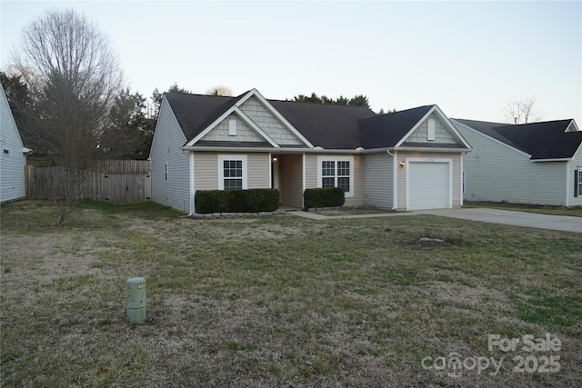 view of front facade featuring an attached garage, fence, a front lawn, and concrete driveway