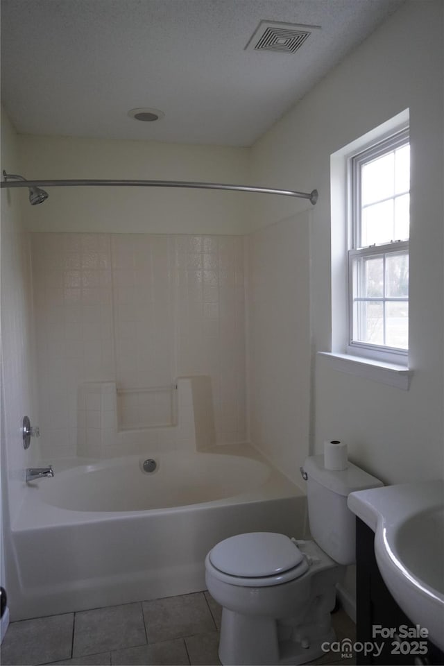 full bathroom with visible vents, bathing tub / shower combination, toilet, tile patterned floors, and vanity