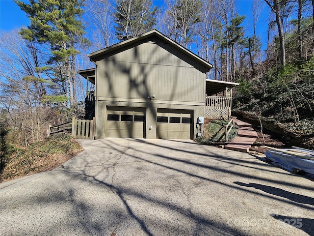 view of home's exterior featuring a garage and aphalt driveway