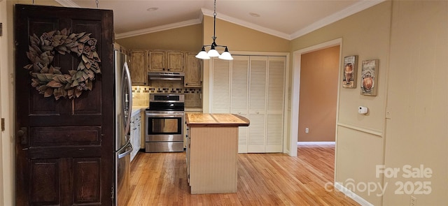 kitchen featuring butcher block countertops, crown molding, appliances with stainless steel finishes, lofted ceiling, and light wood-type flooring
