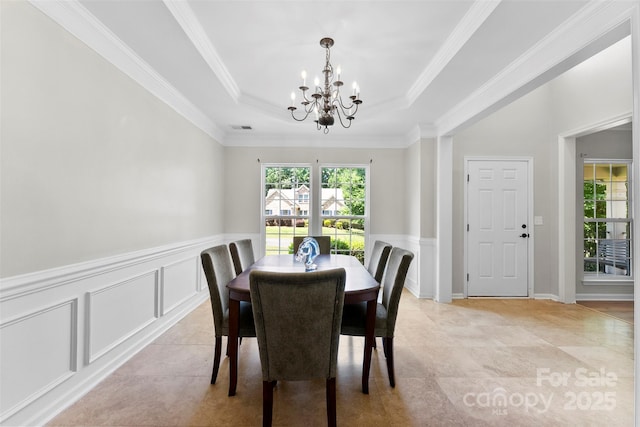 329 Squirrel Ln, Clover, SC 29710 - dining room with a chandelier, a tray ceiling, a decorative wall, a wainscoted wall, and ornamental molding