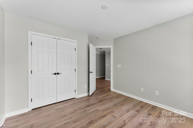 329 Squirrel Ln, Clover, SC 29710 - unfurnished bedroom featuring light wood finished floors and a closet