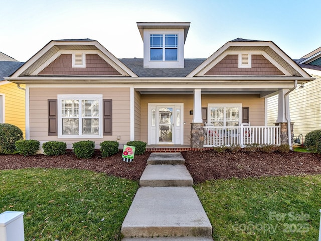 view of front facade with covered porch and a front lawn