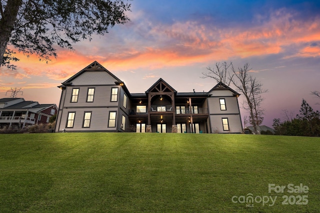 rear view of property with a lawn