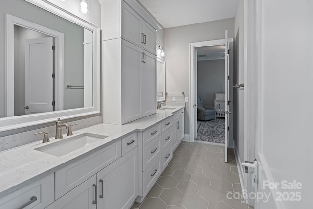 bathroom with double vanity, tile patterned flooring, and a sink