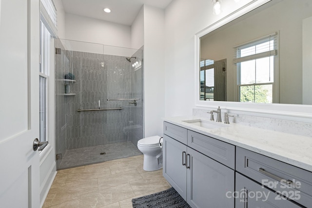 bathroom featuring a stall shower, vanity, toilet, and recessed lighting