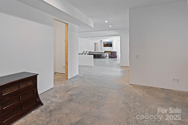 unfurnished room featuring unfinished concrete floors