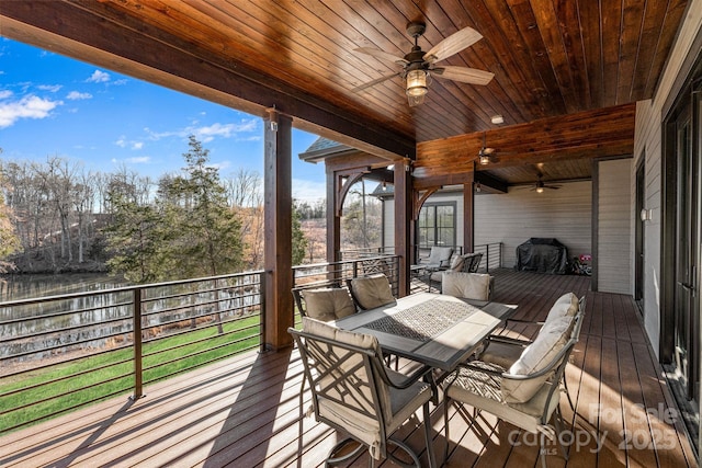 wooden deck with ceiling fan, grilling area, and outdoor dining space