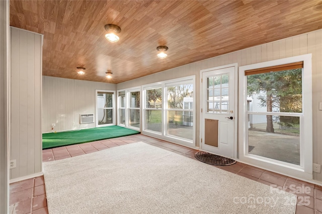 unfurnished sunroom featuring an AC wall unit and wooden ceiling