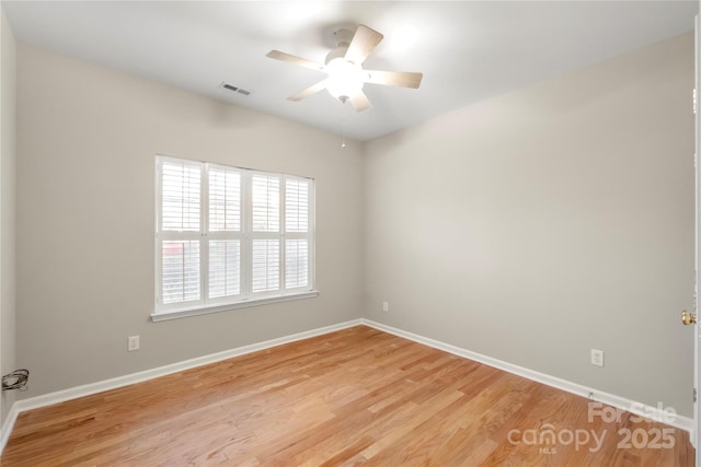 unfurnished room with baseboards, ceiling fan, visible vents, and light wood-style floors